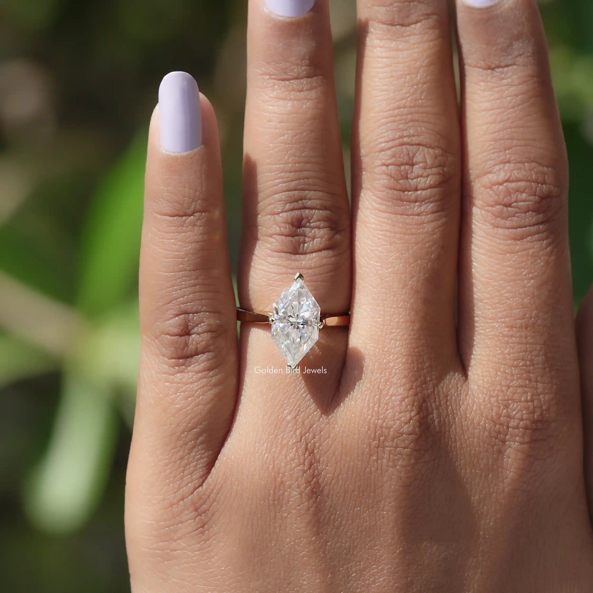 Close-up of 14k Yellow Gold Dutch Marquise Moissanite Ring on finger