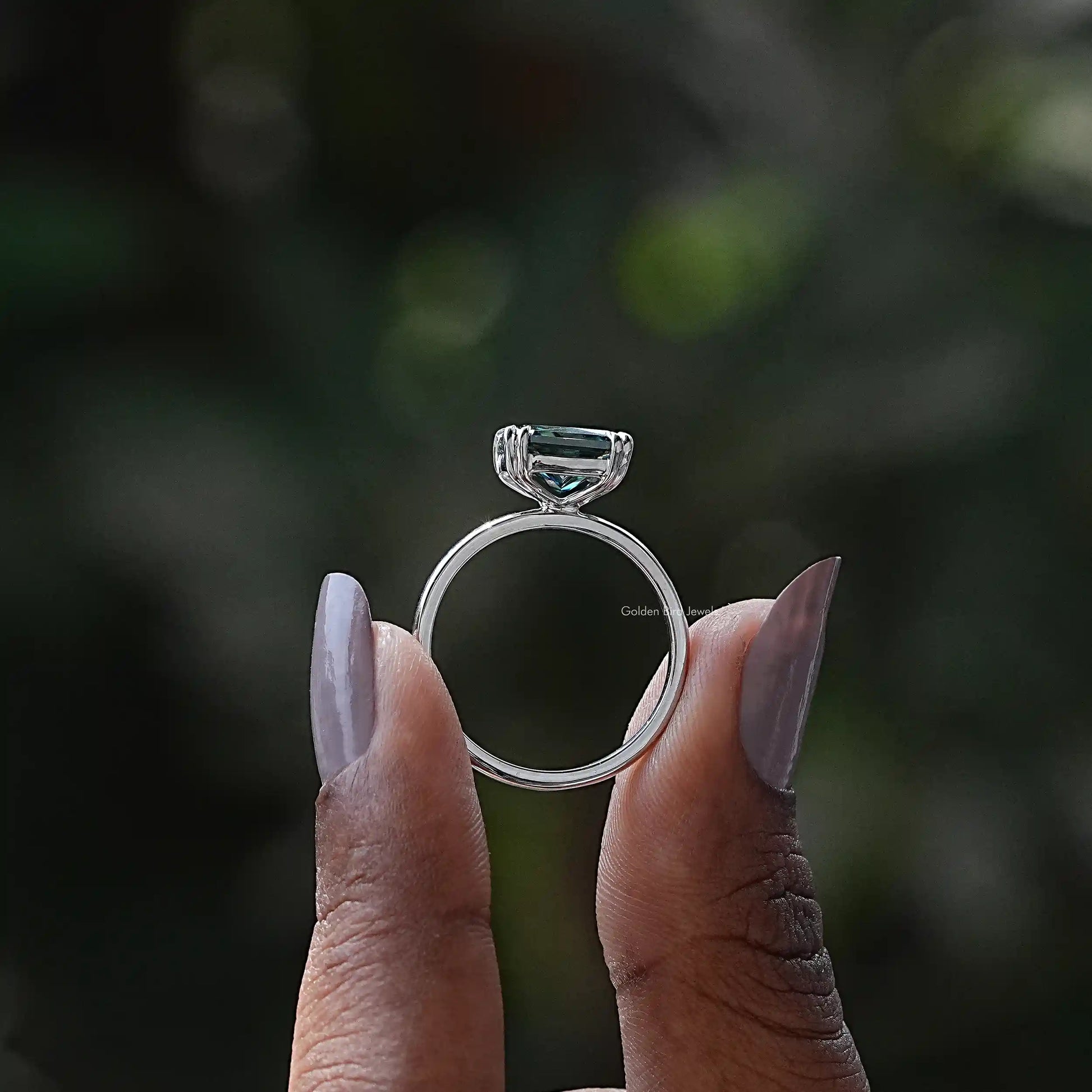 Back View of Radiant Cut Solitaire Engagement Ring In two fingers