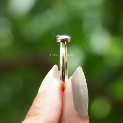 Side View of Cushion Cut Moissanite Engagement Ring In two fingers