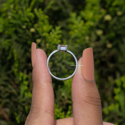 Silver ring back view with square prong setting and orange center gemstone