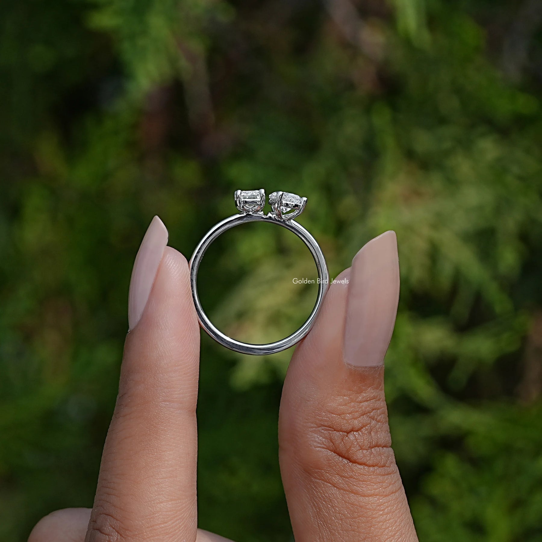 Back View of Emerald And Pear Cut Lab Diamond Ring In two fingers