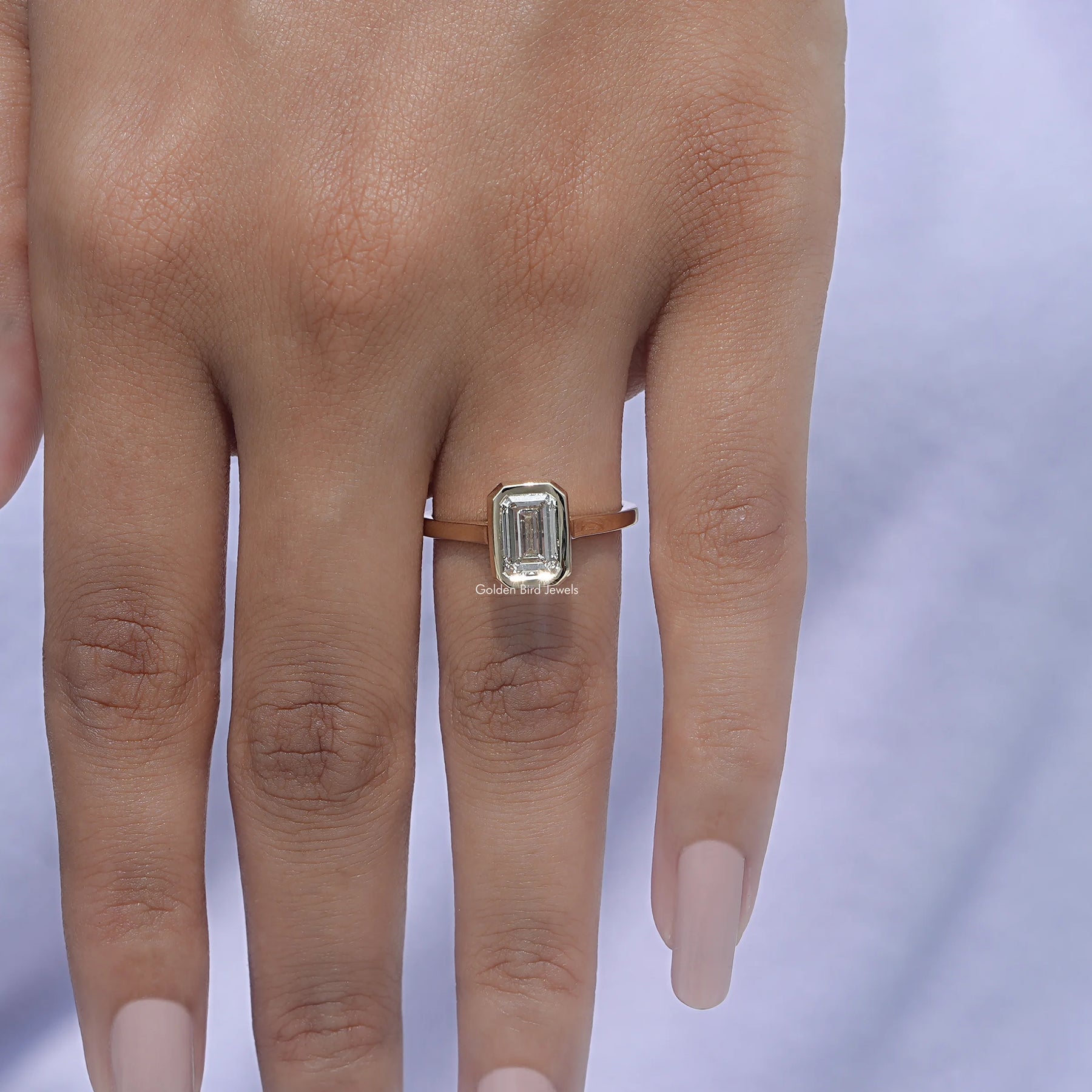 View of A White Gold Emerald Shaped Ring in a finger