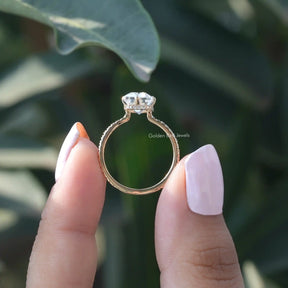 Back View of Emerald And Round Cut Engagement Ring In two fingers