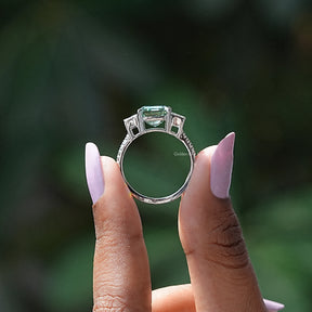 Back View of Emerald Cut Three Stone Ring In two fingers
