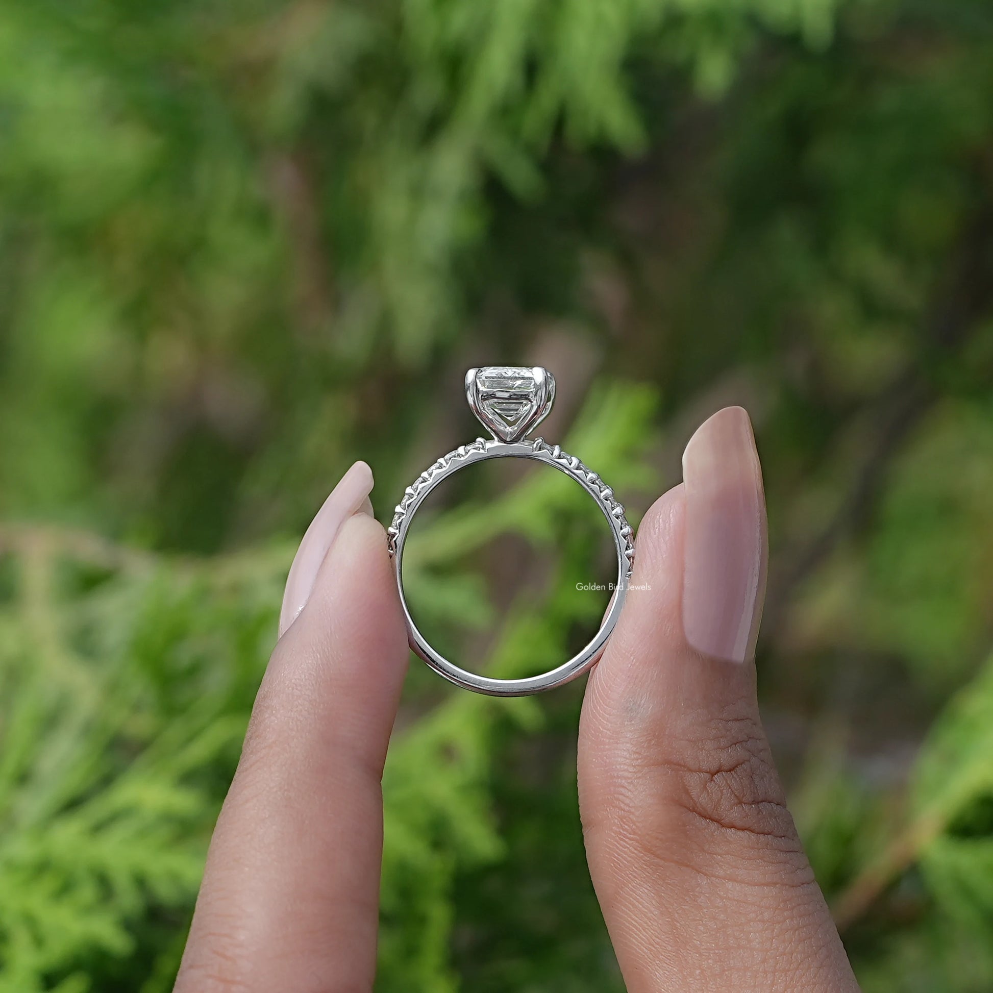 Back View of Emerald Cut Diamond Ring In two fingers