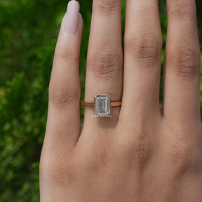 View of A White Gold Emerald Shaped Ring in a two fingers