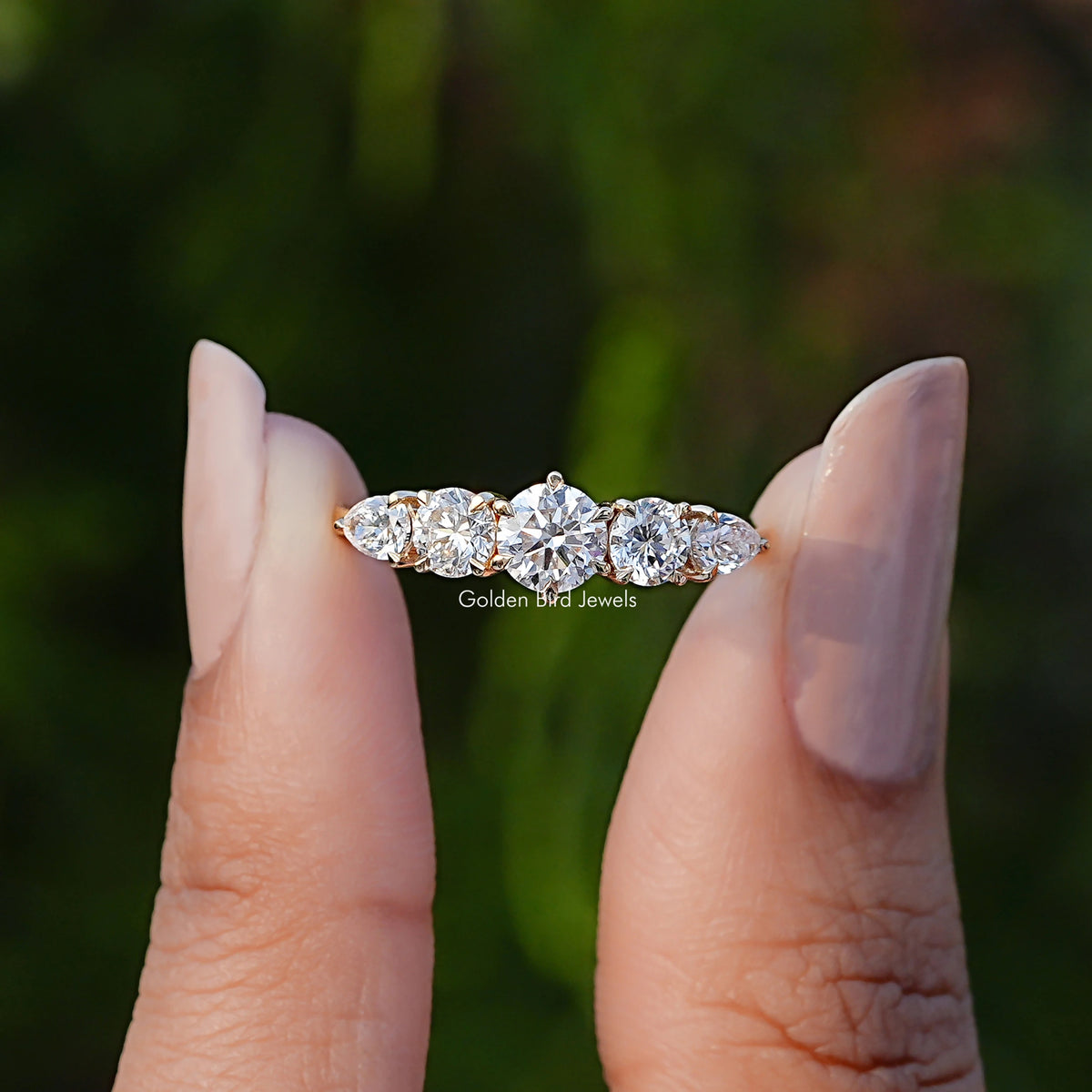 Front View of Round And Pear Cut Lab Diamond Ring In two Fingers