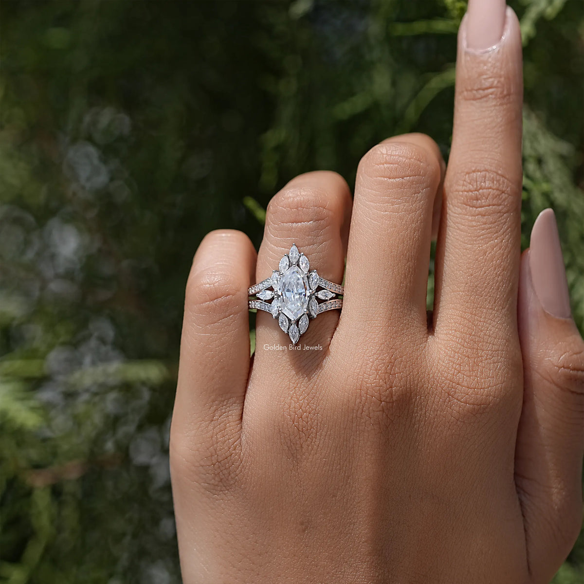 Marquise moissanite halo ring with split shank accents, worn on hand