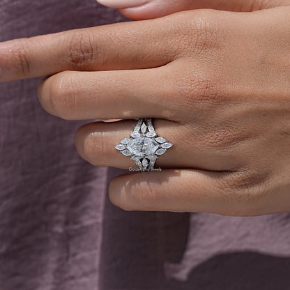 Marquise moissanite halo ring with four-prong center setting, close-up on finger