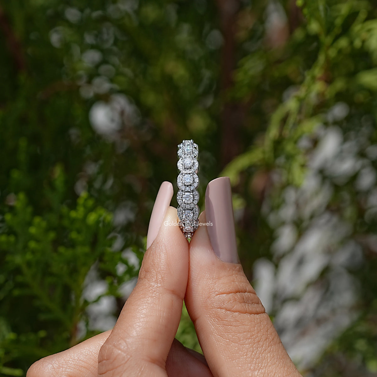 Moissanite eternity band with round halo-set stones