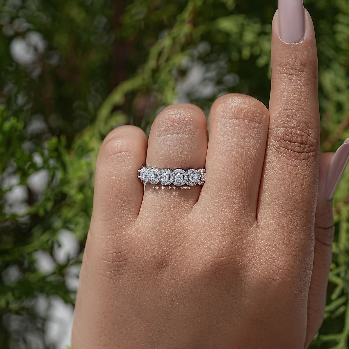 Silver-toned eternity band with small round stones across the top of the finger