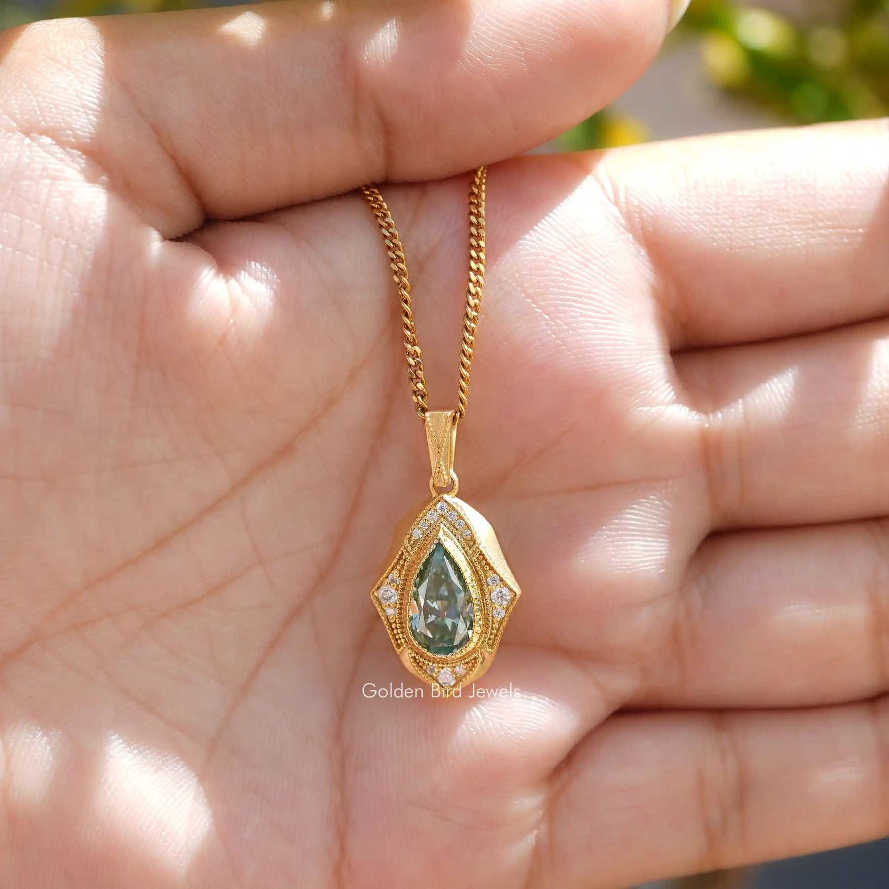 [Front view of pear and round cut moissanite pendant made of yellow gold]-[Golden Bird Jewels]