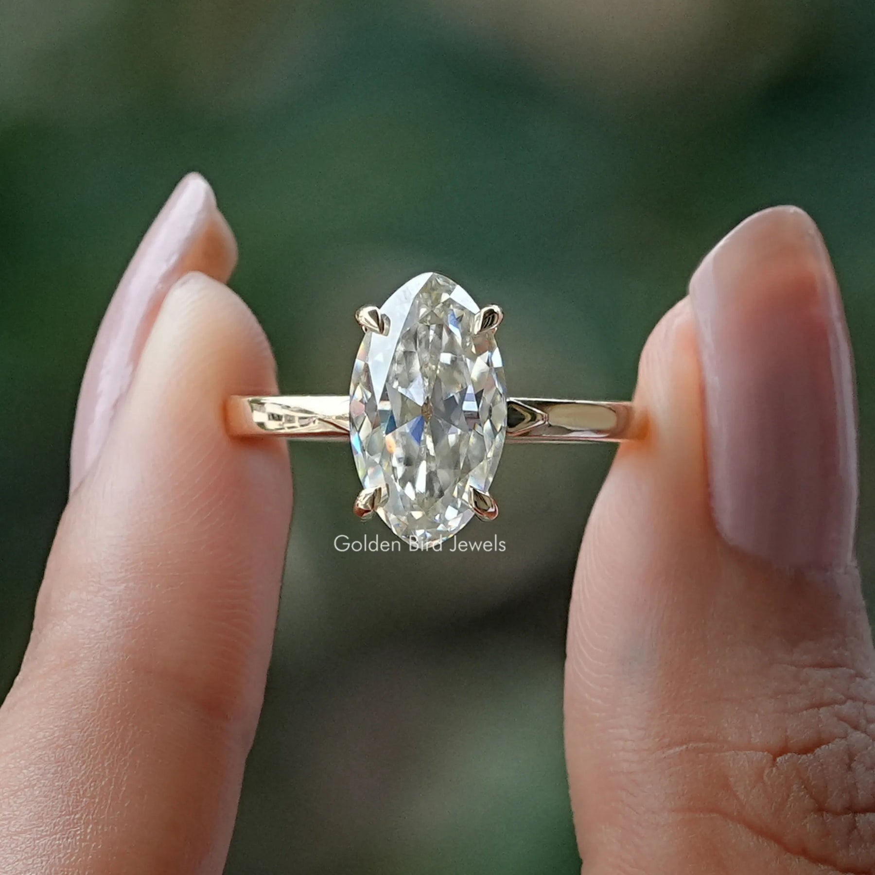 Front View of Old Mine Marquise Moissanite Solitaire Ring In two Fingers