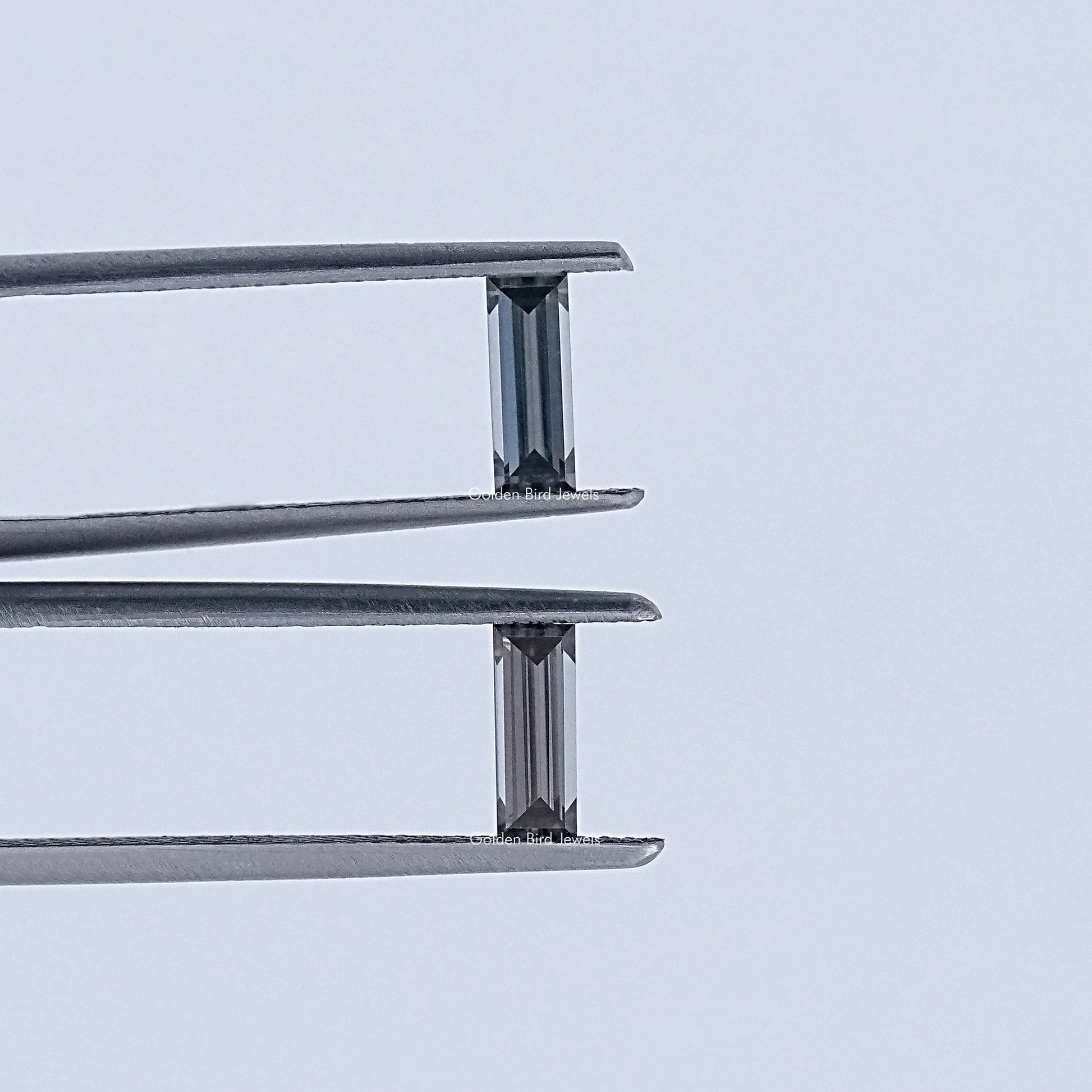 In Tweezer View Of Grey Baguette Cut Loose Moissanite Pair