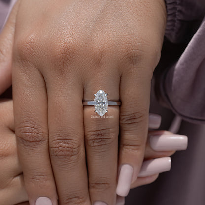 Oval moissanite solitaire ring close-up on hand, four-prong oval stone