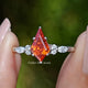 Front view of Orange Kite Cut Gemstone Accent Ring in two fingers 