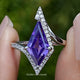 Front view of Amethyst Kite Gemstone Accent Ring in two fingers 