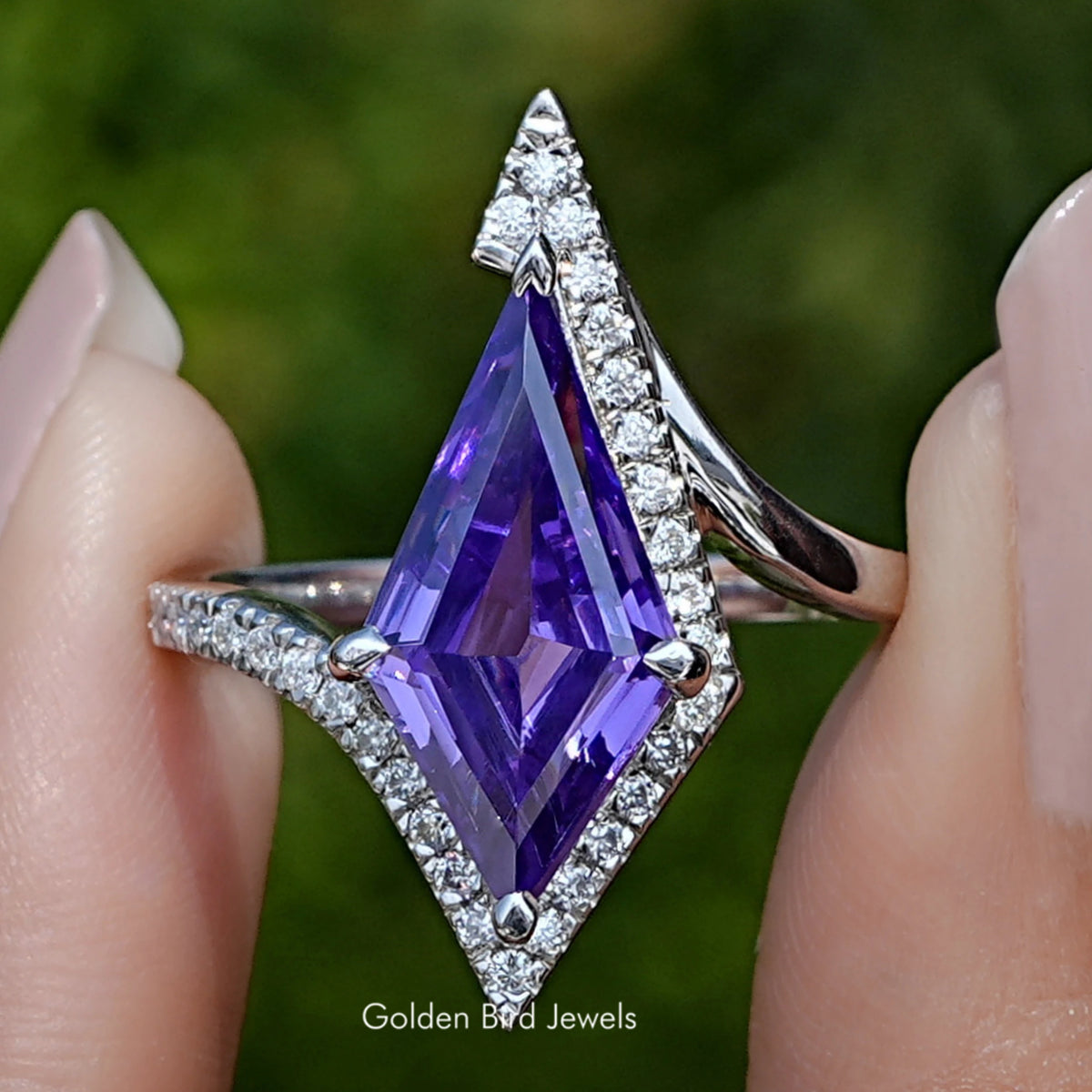Front view of Amethyst Kite Gemstone Accent Ring in two fingers 