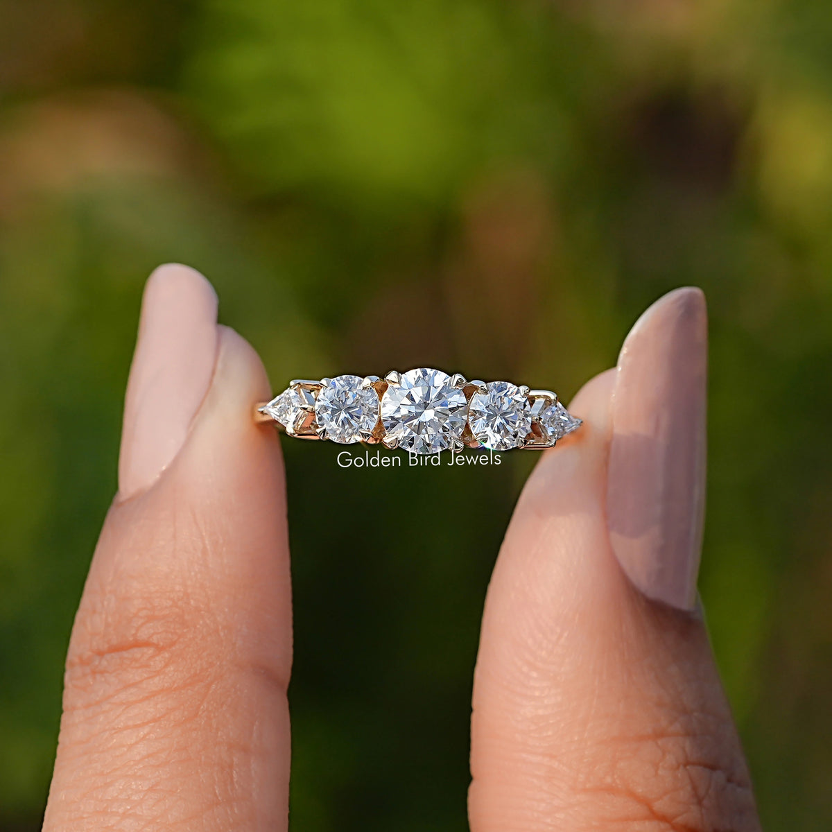 Front View of Kite And Round Cut Lab Diamond 5 Stone Ring In two Fingers