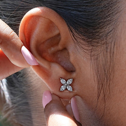 In detailed ear view of flower style stud diamond earings 