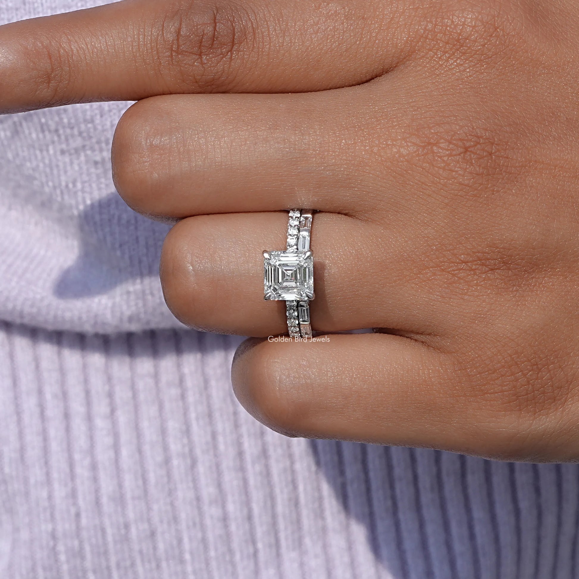 Emerald Shaped lab Diamond Wedding Ring Set on a finger, front view