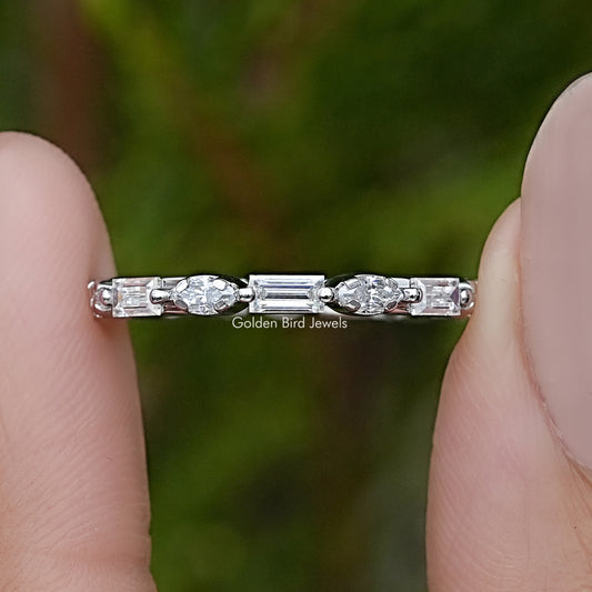 Silver marquise eternity wedding band with baguette-cut stones, side close-up on fingers