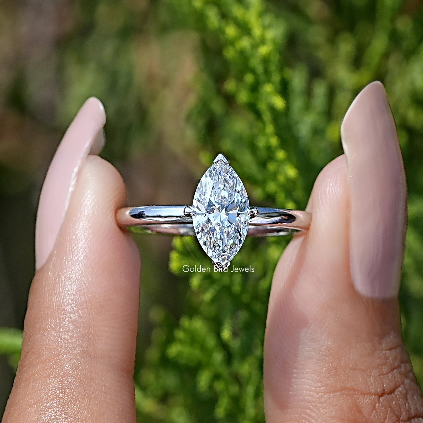 Front View of Marquise Cut  Diamond Solitare Ring in two fingers 