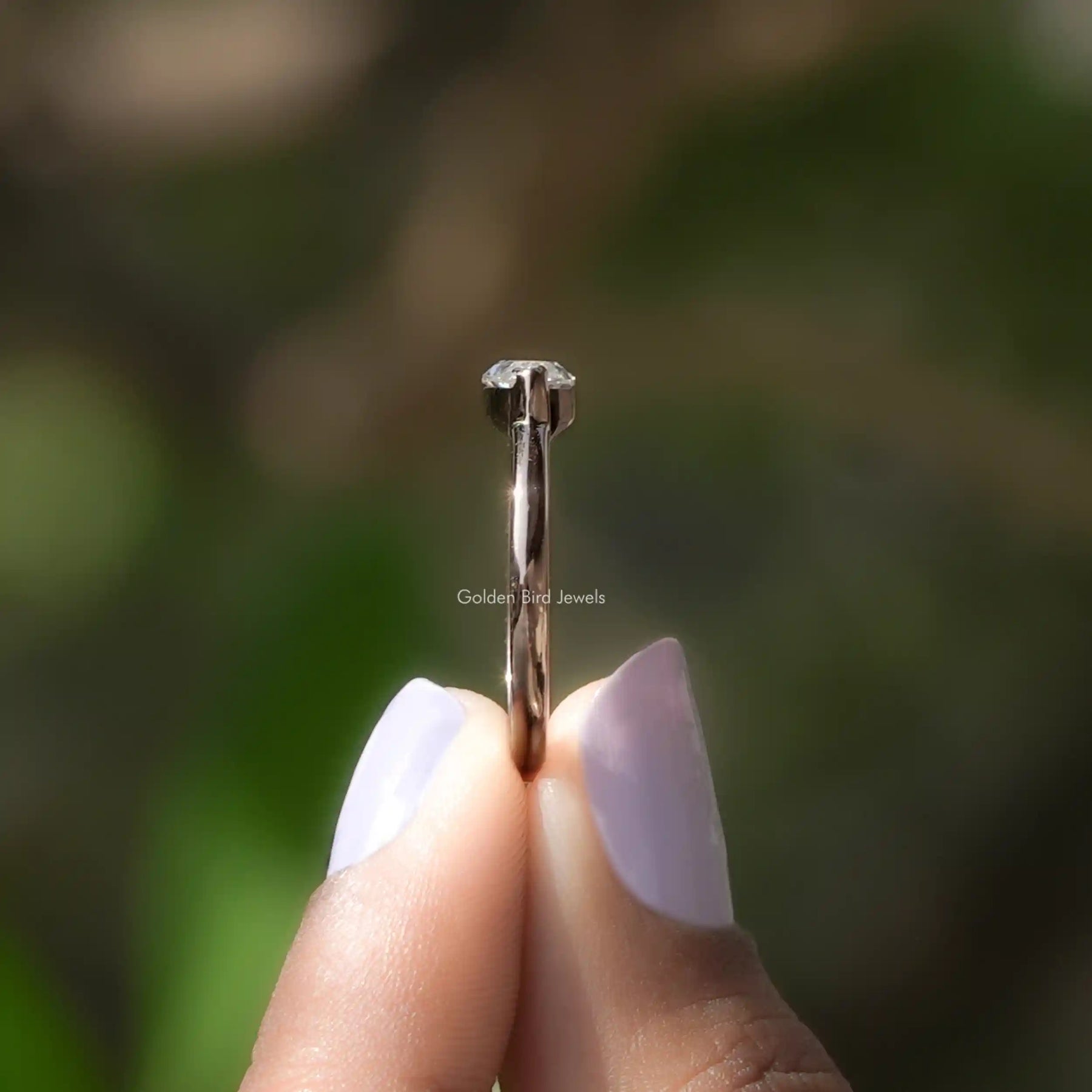 Side View of Solitaire Marquise Cut East West Ring In two fingers