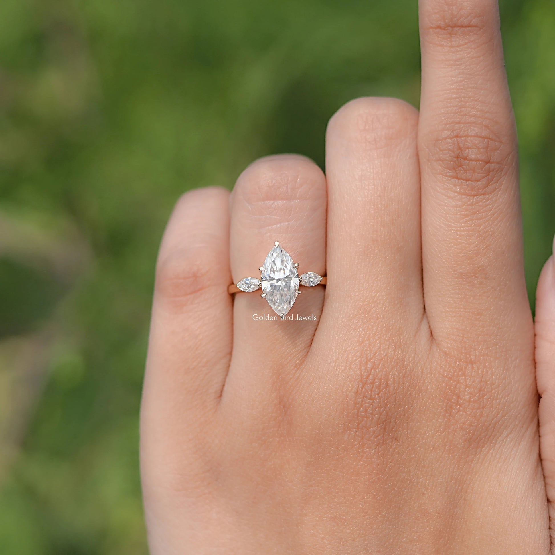 In finger front view of Marquise Cut Moissanite Three Stone Ring
