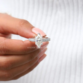 Top view of Halo Marquise moissanite ring holding in two fingers 