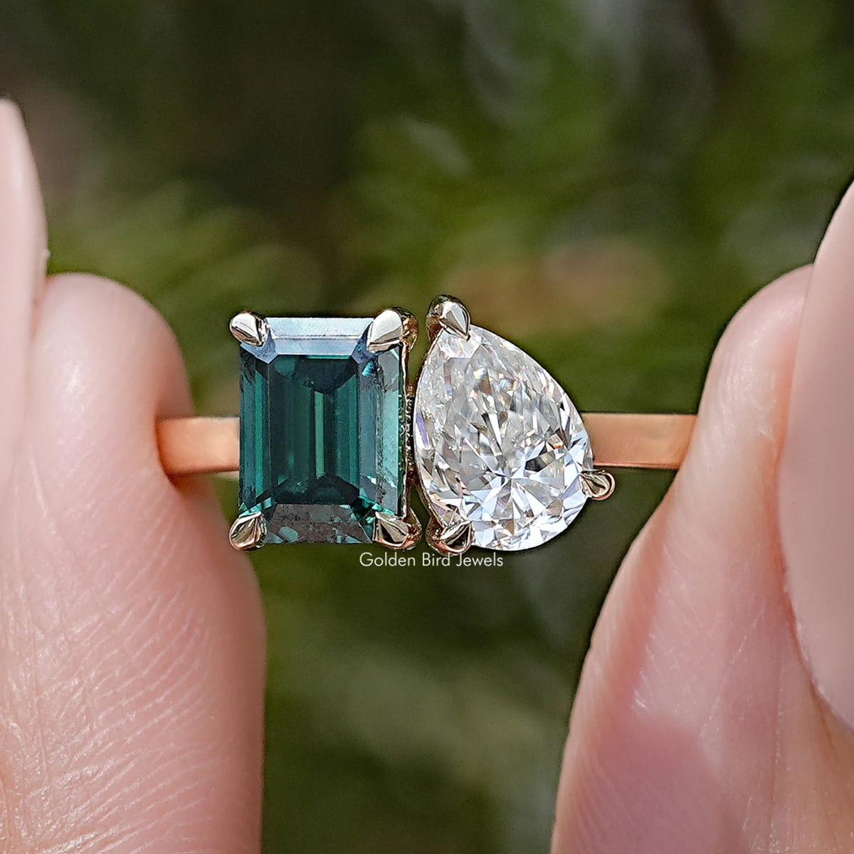 Two-stone ring: emerald-cut green and round white stones, prong-set
