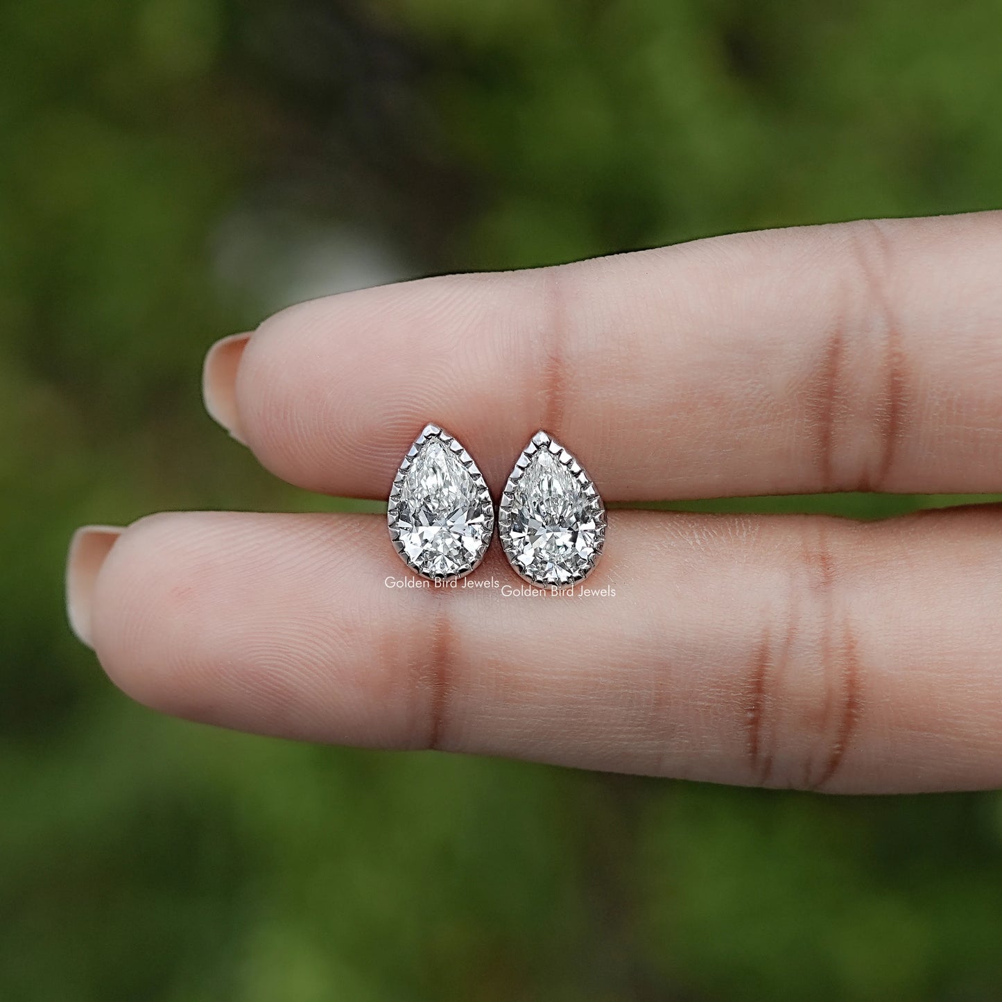 In Hand View Of Pear  Cut Lab Diamond Bezel Studs