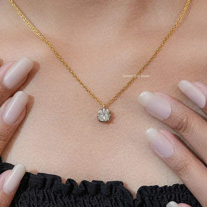 Round cushion-cut moissanite pendant on gold tone chain, worn at neckline