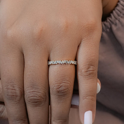 Gold-tone lab diamond half eternity band ring with baguette stones, close-up on hand
