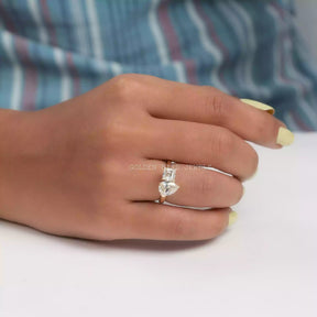 In finger front view of toi et moi moissanite  ring in yellow gold 