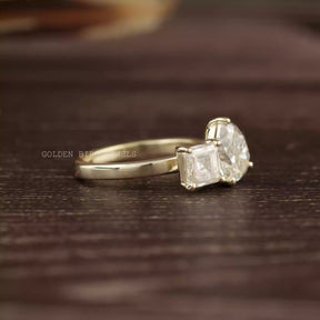Side view of Pear and asscher cut moissanite   engagement ring 
