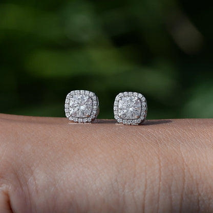 In Hand View Of a cushion cut moissanite stud Earring 