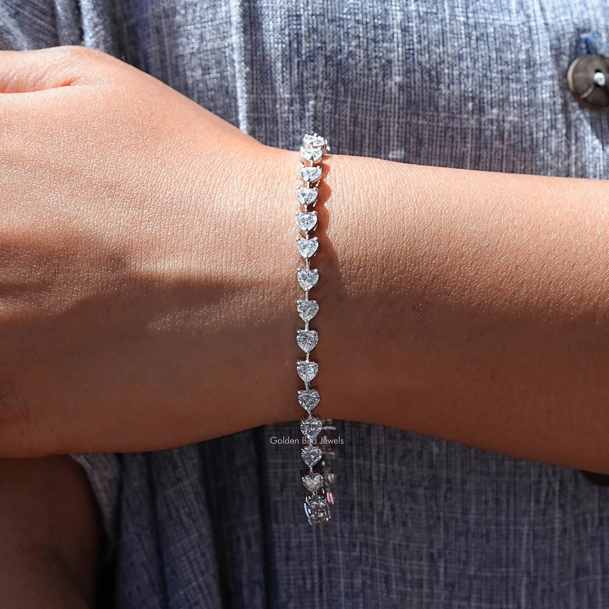 In hand view of Heart moissanite halo bracelet