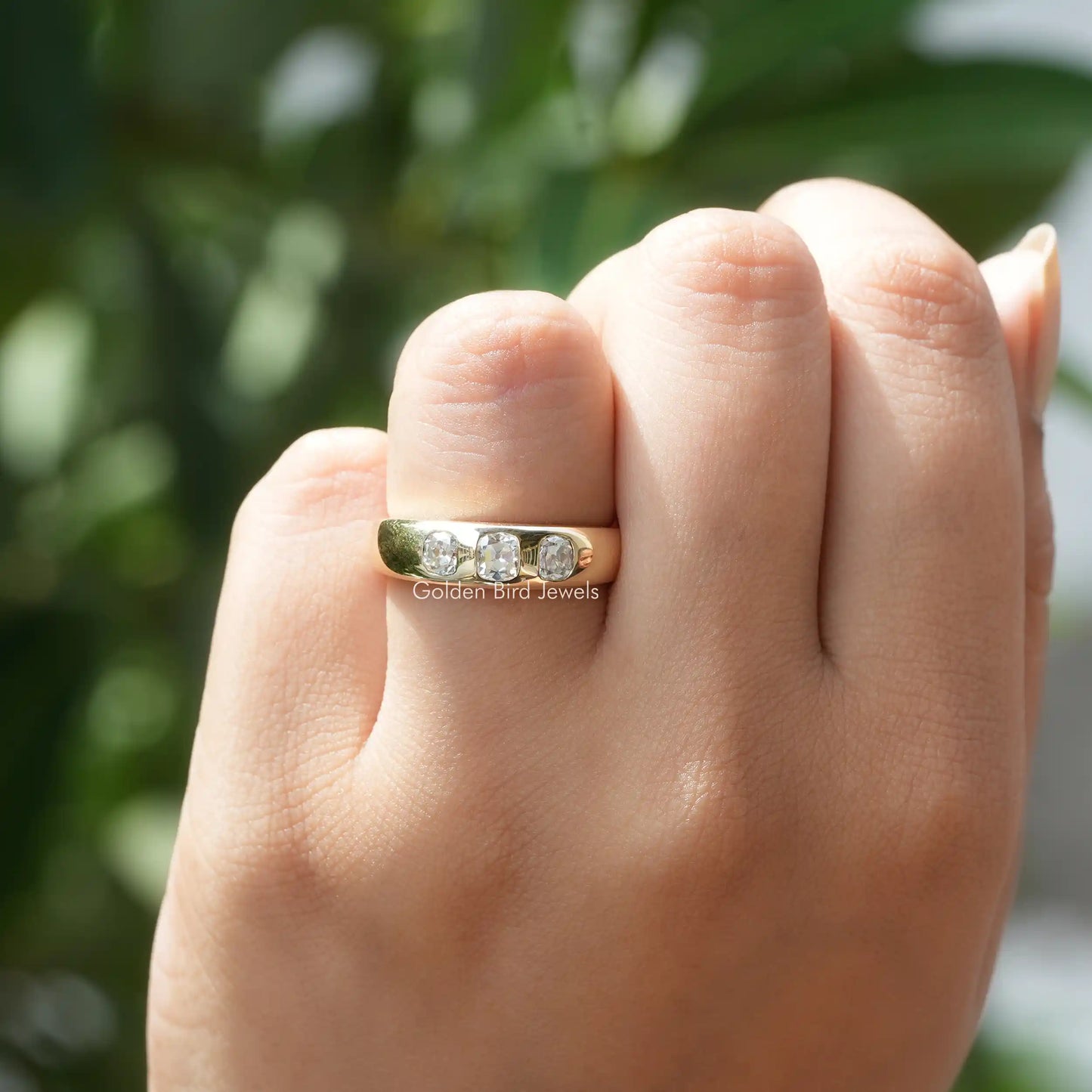 In hand showing a view of moissanite Ring	 		