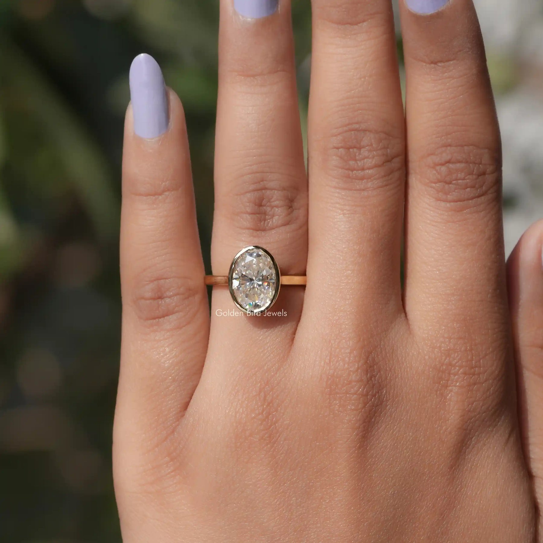 View of Bezel Set Oval Cut Moissanite Ring In Yellow Gold