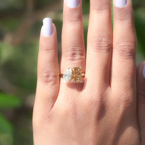 In finger front view of fancy colored moissanite wedding ring 

