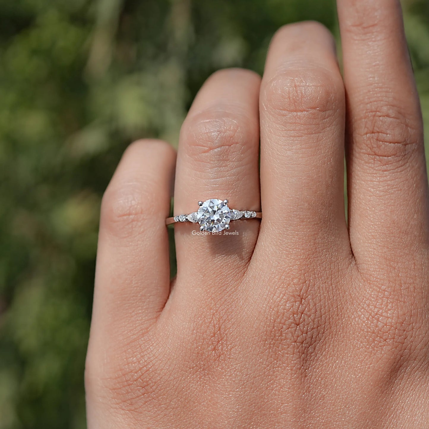 In finger view of Round Cut Moissanite Accent Set Engagement Ring