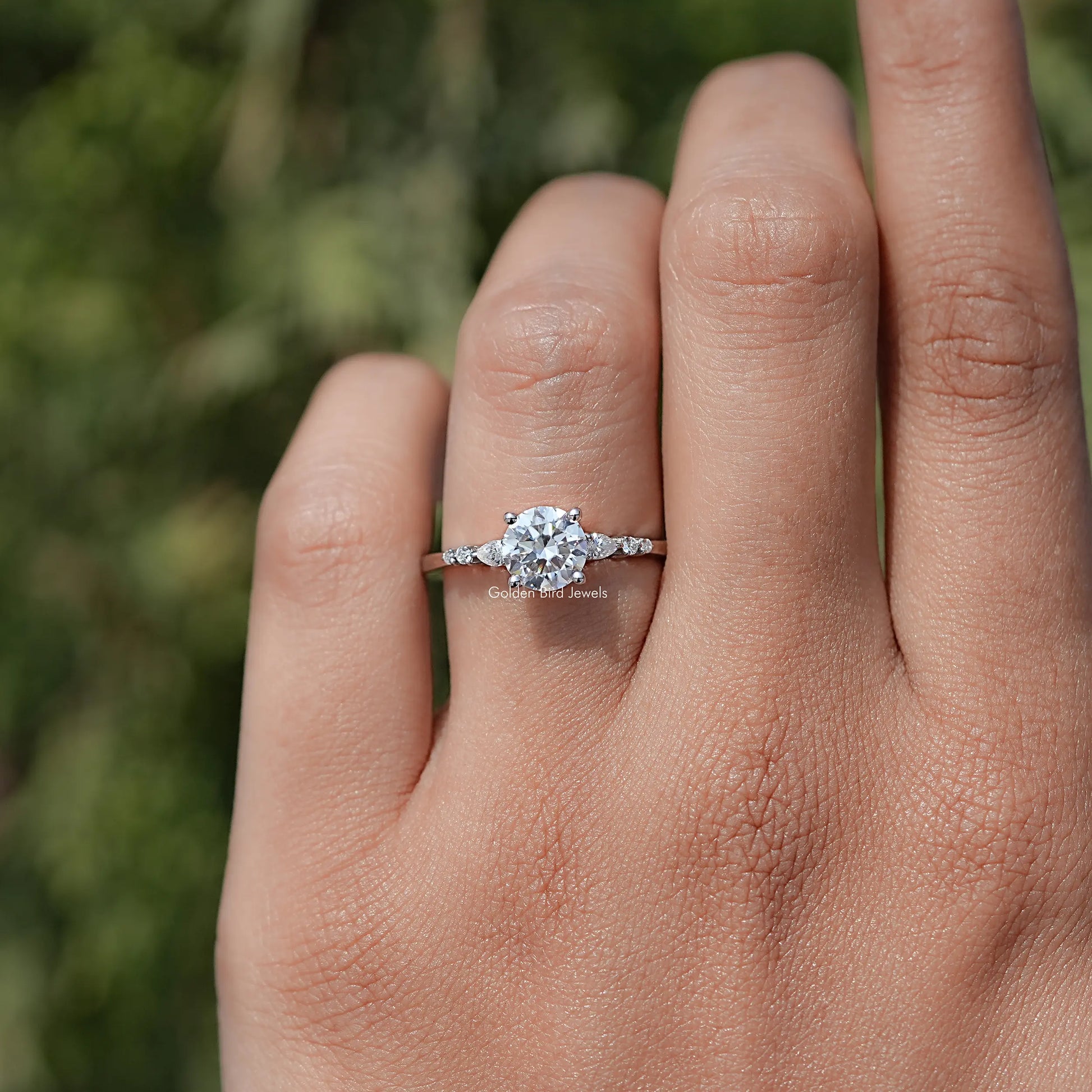 In finger view of Round Cut Moissanite Accent Set Engagement Ring