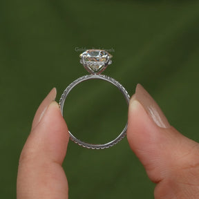 Back View of Moissanite Round Cut Engagement Ring In two fingers