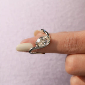 In finger front View of Ice Oval Cut Moissanite Curved Ring