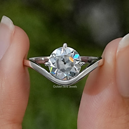 Sterling silver solitaire ring with a round moissanite and curved band