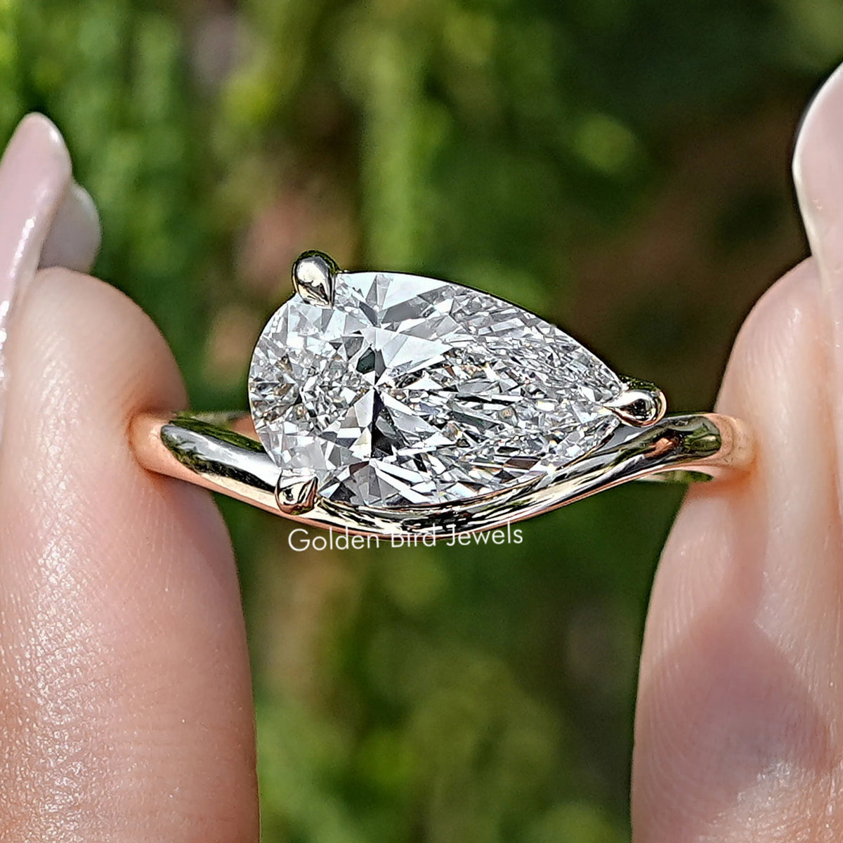 Front view of Pear Lab Diamond Curved Solitaire Ring in two fingers 