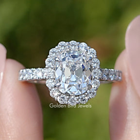 Front view of Old Mine Cushion Cut Lab Diamond Halo Ring in two fingers 