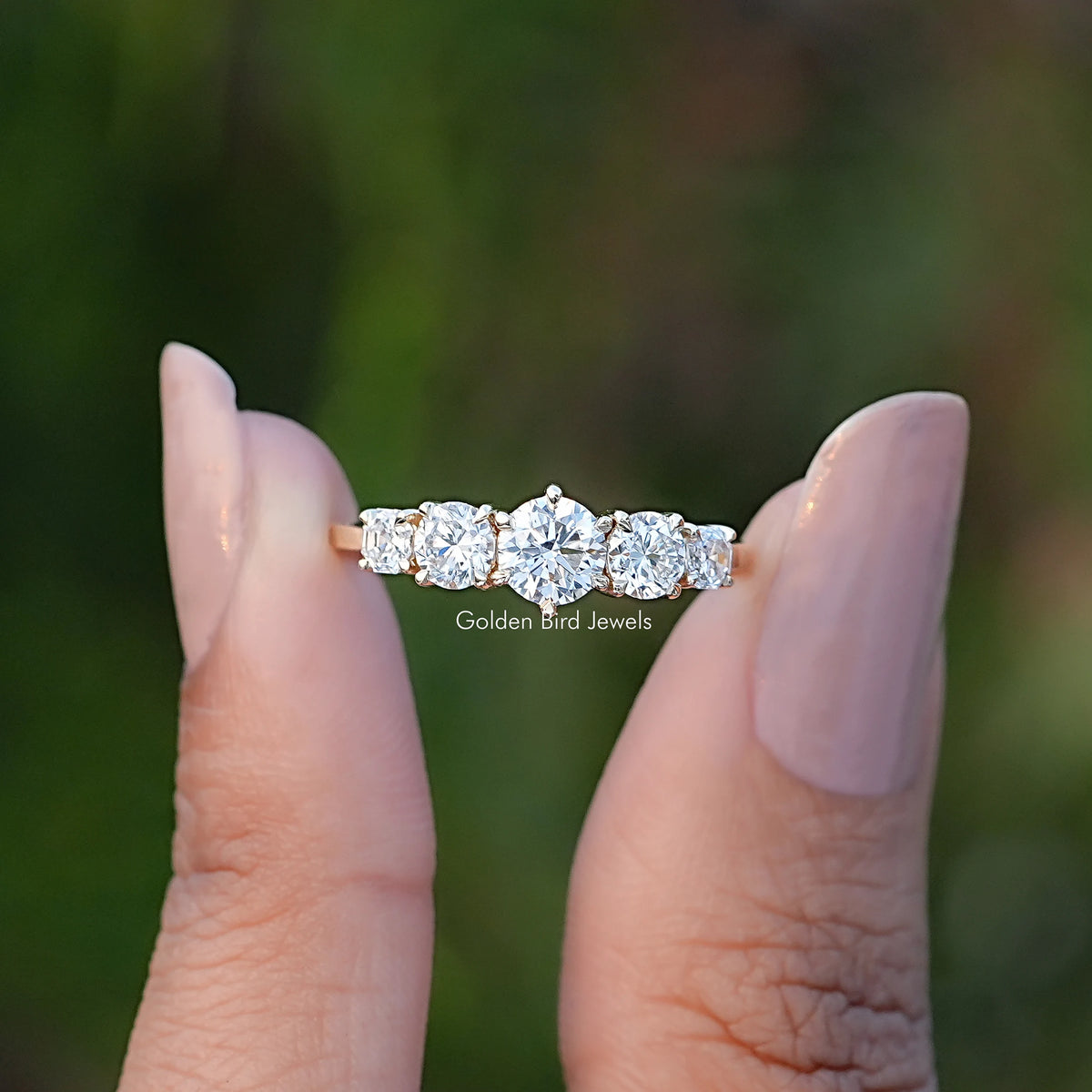 Front View of Octagon And Round Cut Lab Diamond Five Stone Ring In two Fingers