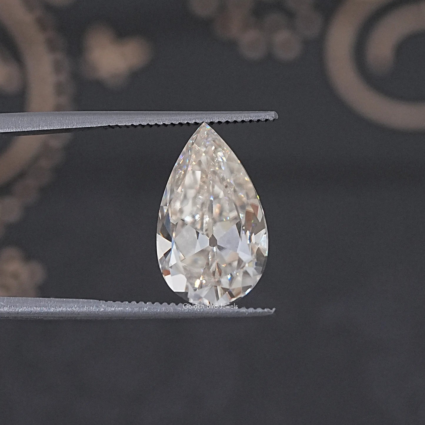 In Tweezer View Of Old Mine Pear Cut Loose Moissanite Stone